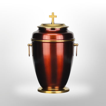 Metallurne in Rot mit Goldverzierung und Kreuz